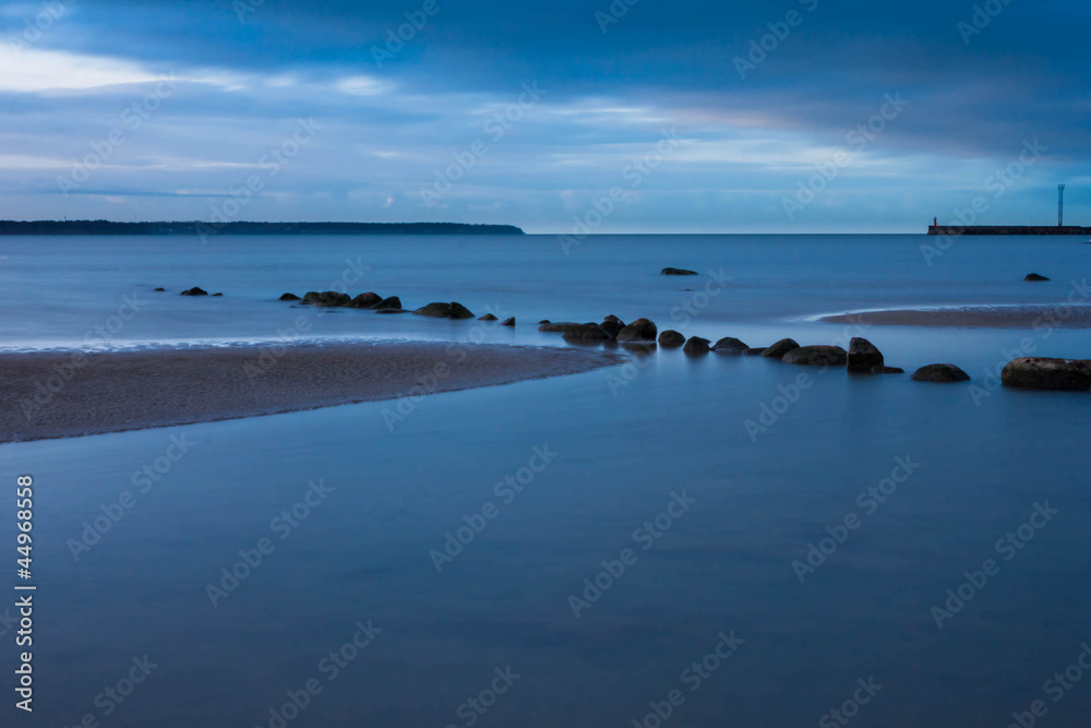 View of a rocky coast in the evening. Long exposure shot.