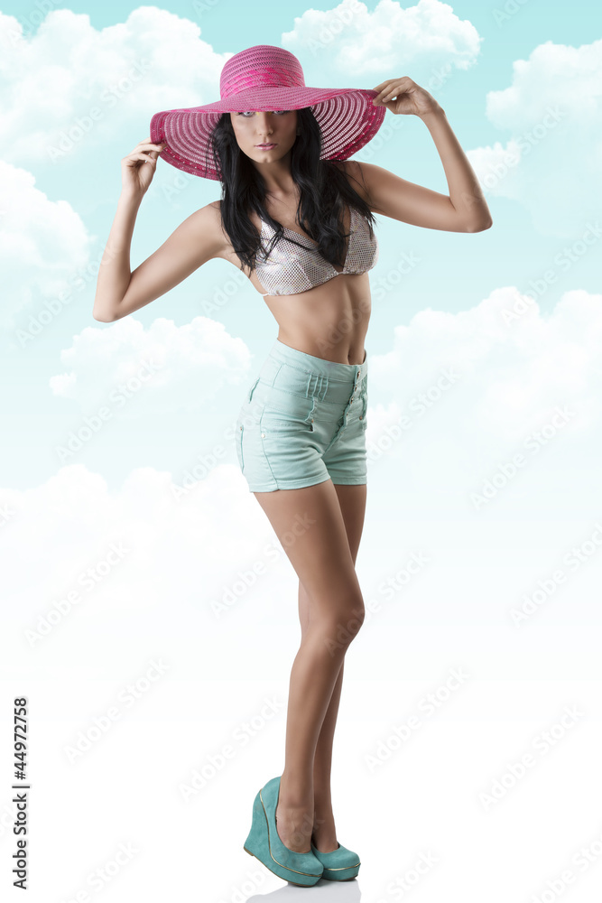sexy brunette with shorts and hat turned of three quarters sexy brunette with shorts and hat turned of three quarters