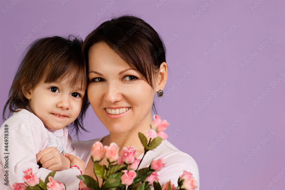 Happy Caucasian female with a daughter and flowers Happy Caucasian female with a daughter and flowers