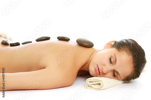 An attractive woman getting spa treatment, isolated on white