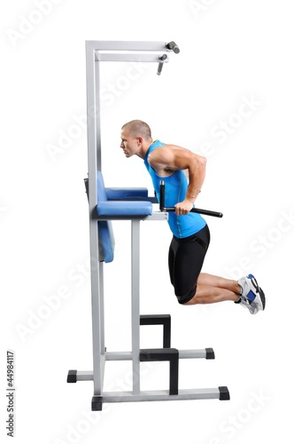 Muscular athlete man exercising on a white background