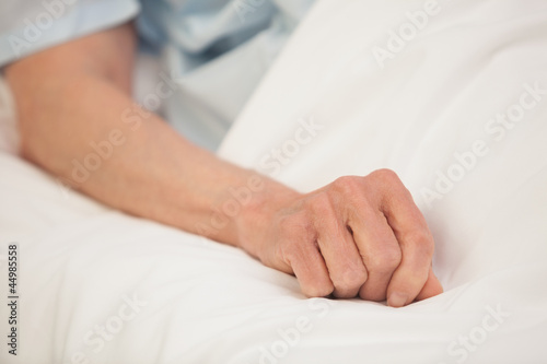 Elderly arm in hospital bed