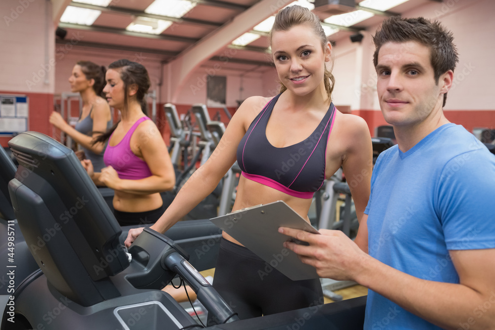 Fototapeta premium Gym Instructor and woman in the gym
