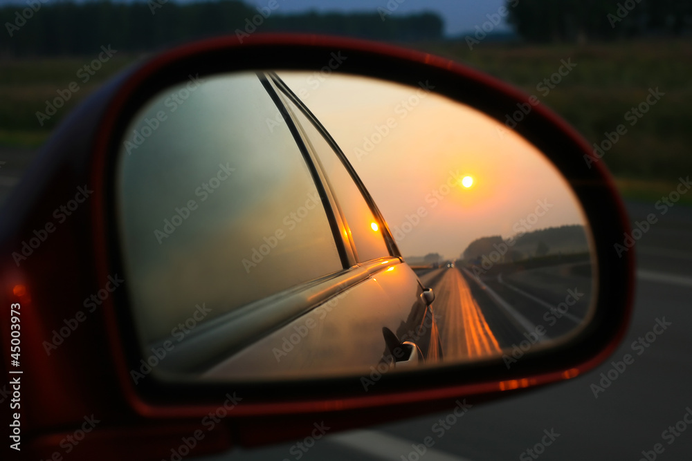 Sunset in mirror of car