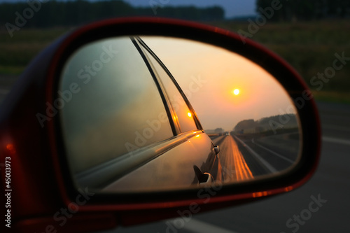 Sunset in mirror of car