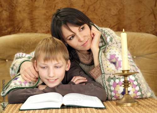 Luck nice Caucasian mom with her son reading a book