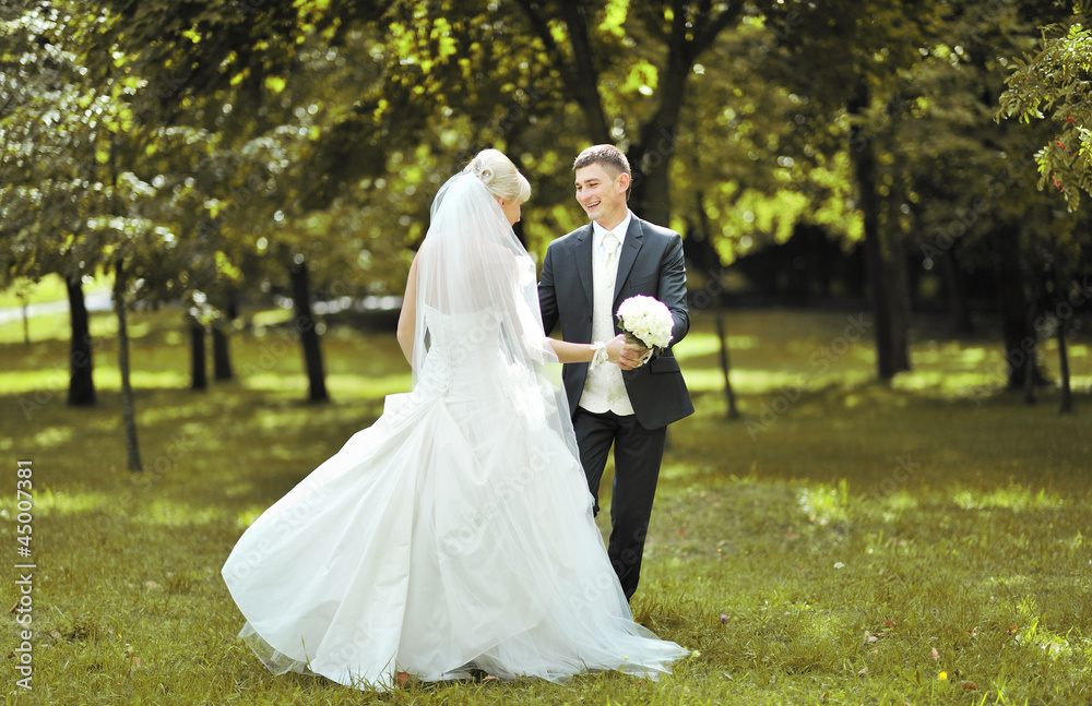 Beautiful bride and groom dancing outside at their wedding day