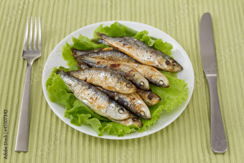fried sardines on the plate