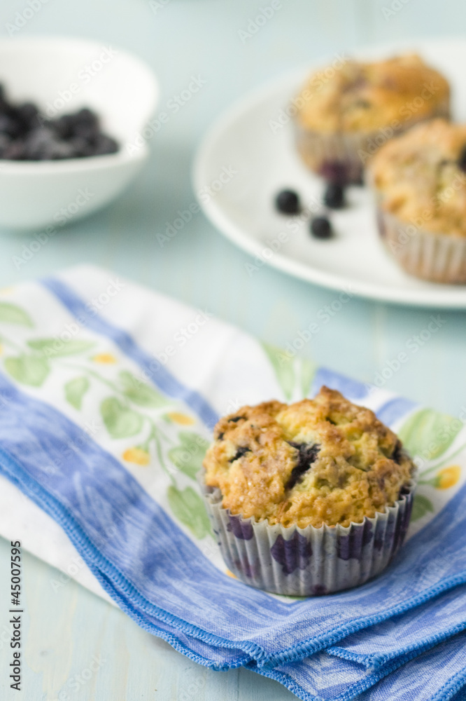 Blueberry muffin on napkin withfresh berries Blueberry muffin on napkin withfresh berries