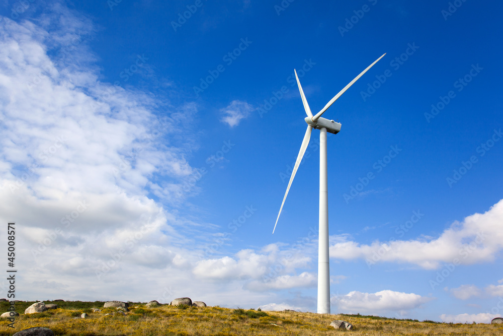 Windmill in the top of a mountain against beautiful sky Windmill in the top of a mountain against beautiful sky