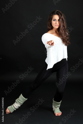 young modern dancer posing, isolated on black