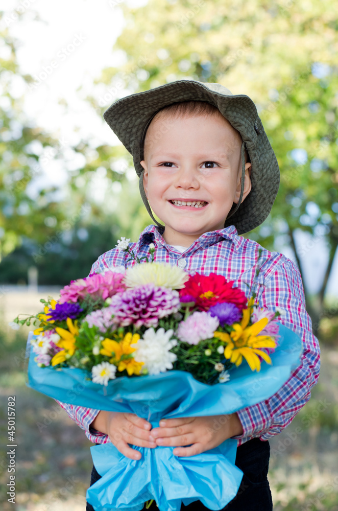 Grinning young boy with flowers Grinning young boy with flowers
