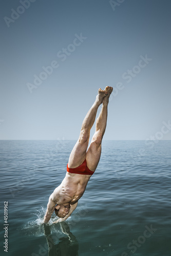 man jumping in the lake