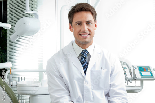 Happy Male Dentist In Clinic