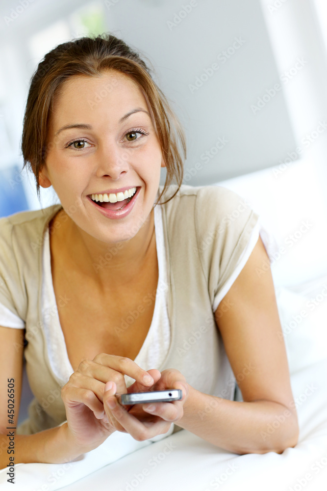 Young woman sending short message with telephone Young woman sending short message with telephone