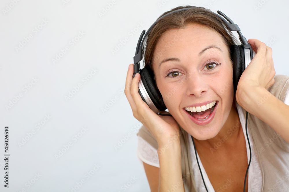 Cheerful woman with headphones, isolated