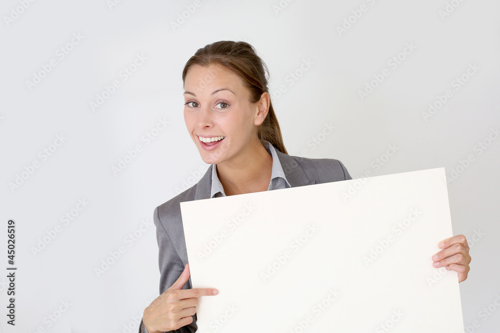 Businesswoman holding whiteboard with texspace Businesswoman holding whiteboard with texspace