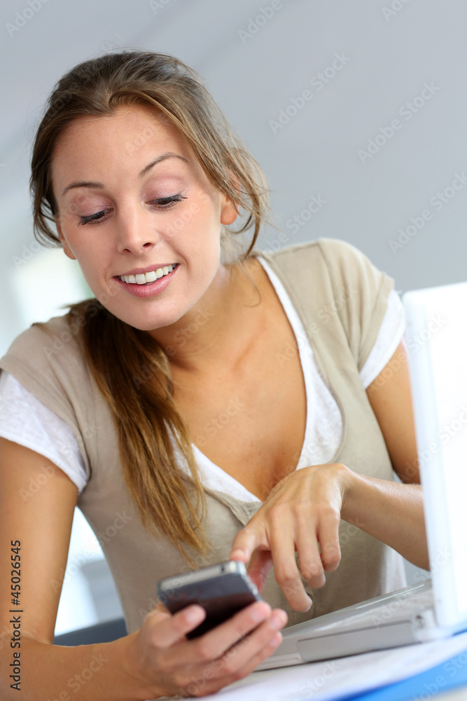 Young woman happy to read message on telephone Young woman happy to read message on telephone