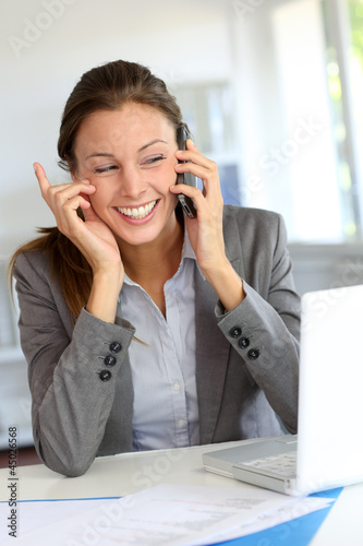 Businesswoman on the phone laughing outloud