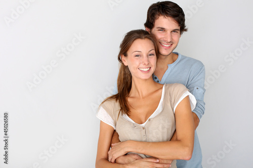Cheerful young couple standing on white background, isolated