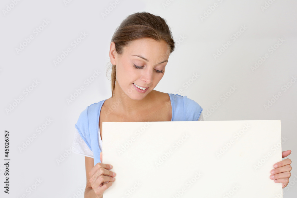 Cheerful young woman holding whiteboard , isolated Cheerful young woman holding whiteboard , isolated