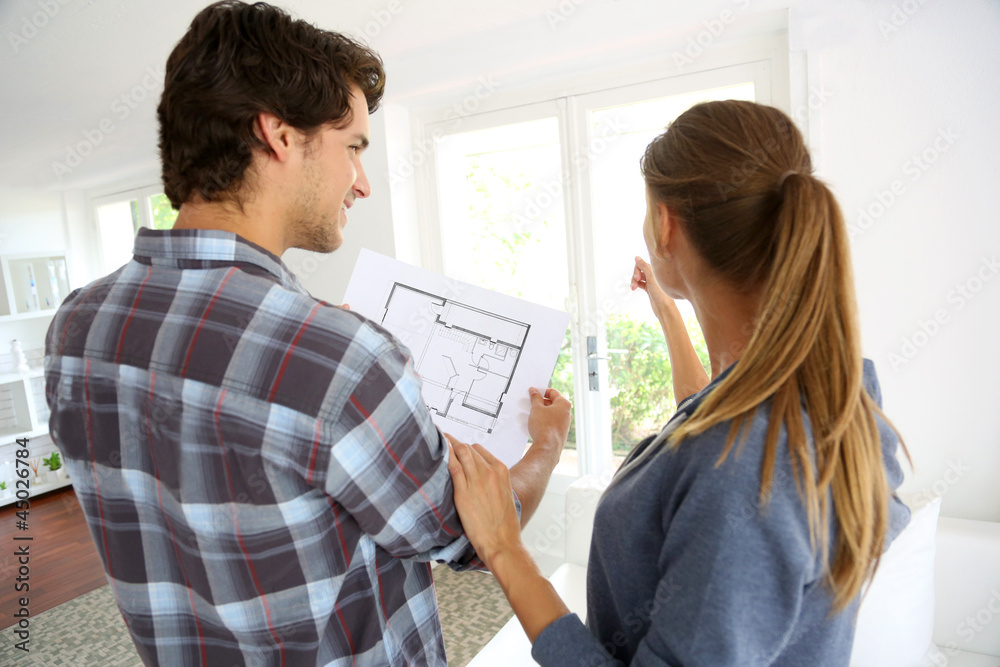 New property owners looking at home blueprint New property owners looking at home blueprint