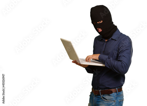 young male thief holding laptop