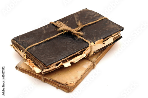 Stack of old books tied with rope isolated on white