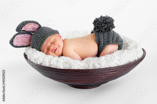 smiling newborn baby boy wearing a gray bunny rabbit costume