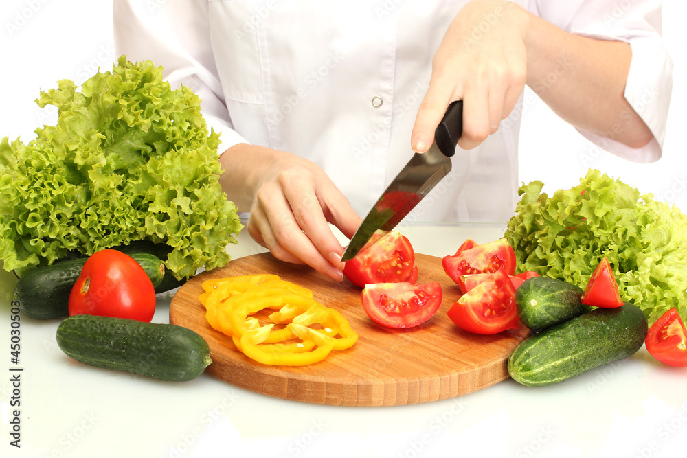 woman hands cutting vegetables on kitchen blackboard woman hands cutting vegetables on kitchen blackboard