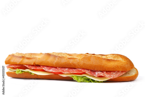 Long sandwich with salami tomatoes isolated on white