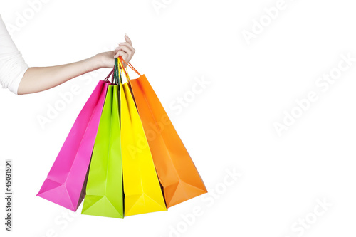 Female hand holding colorful shopping bags