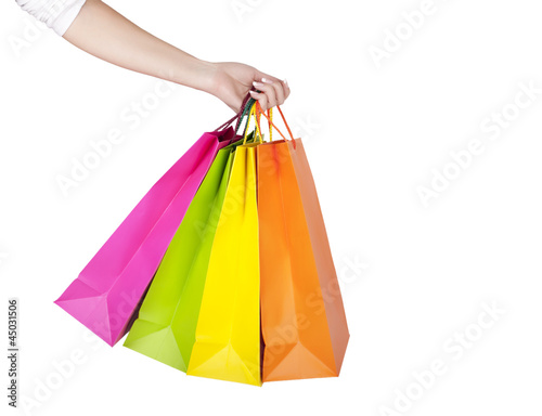 Female hand holding colorful shopping bags