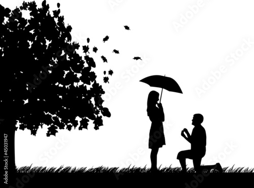 Romantic proposal in park of a man proposing to a woman
