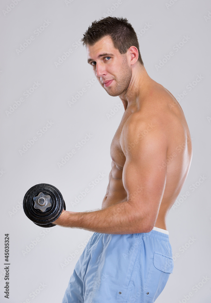 Strong sports man workout biceps with dumbbell Strong sports man workout biceps with dumbbell