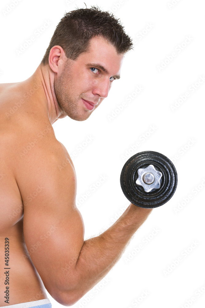 Athletic man with strong biceps rising dumbbell Athletic man with strong biceps rising dumbbell