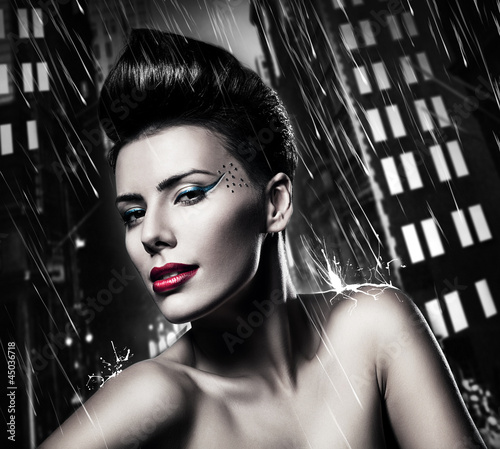sexy brunette woman with red lips in rainy city