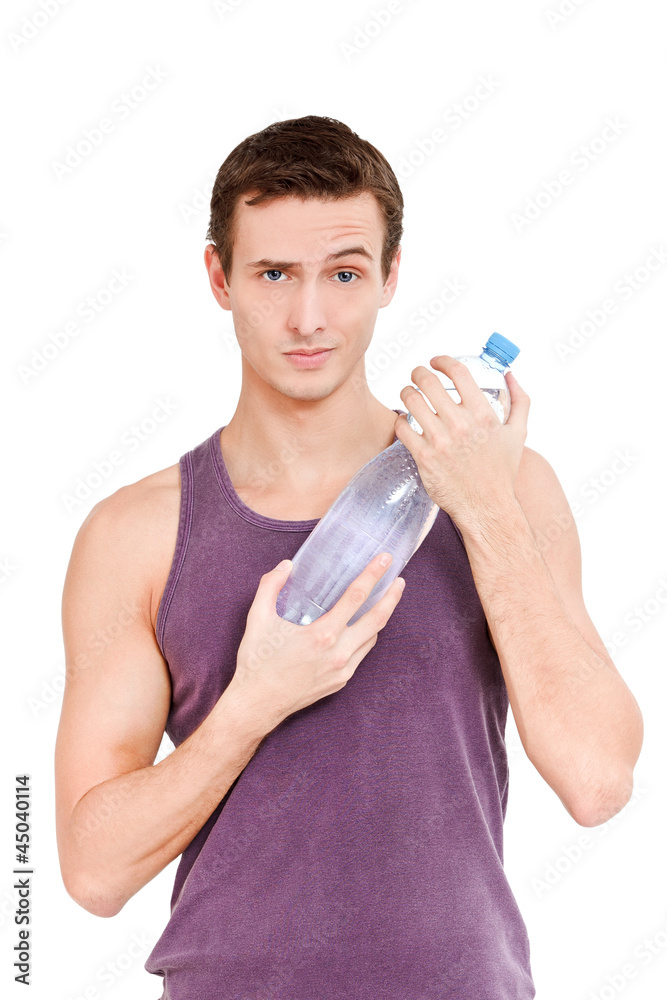 Young man holding PET bottle of water raising eyebrow Young man holding PET bottle of water raising eyebrow