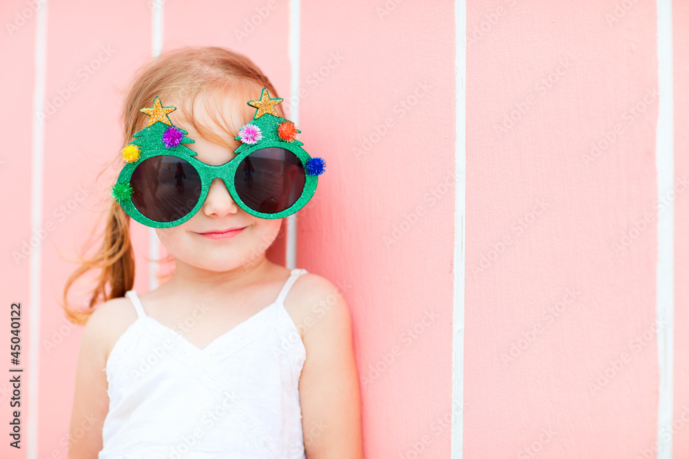 Little girl in funny Christmas glasses