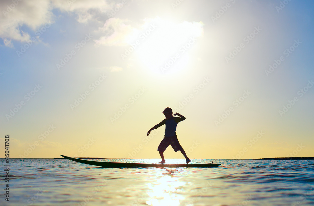 Silhouette of a boy on surfboard Silhouette of a boy on surfboard