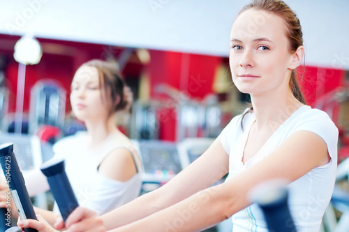 Free Download Two young sporty women run on machine - GFXLoad