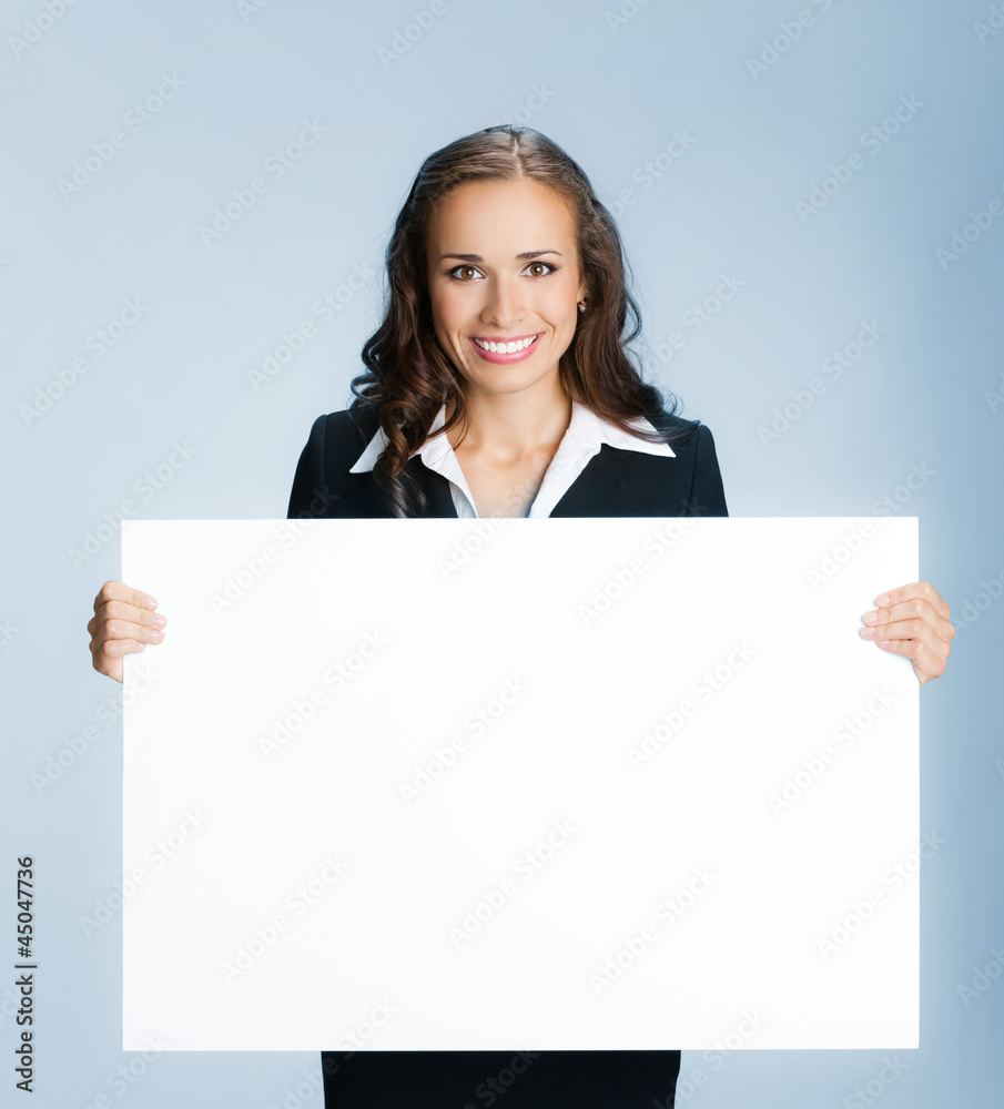 Businesswoman showing signboard, over blue Businesswoman showing signboard, over blue
