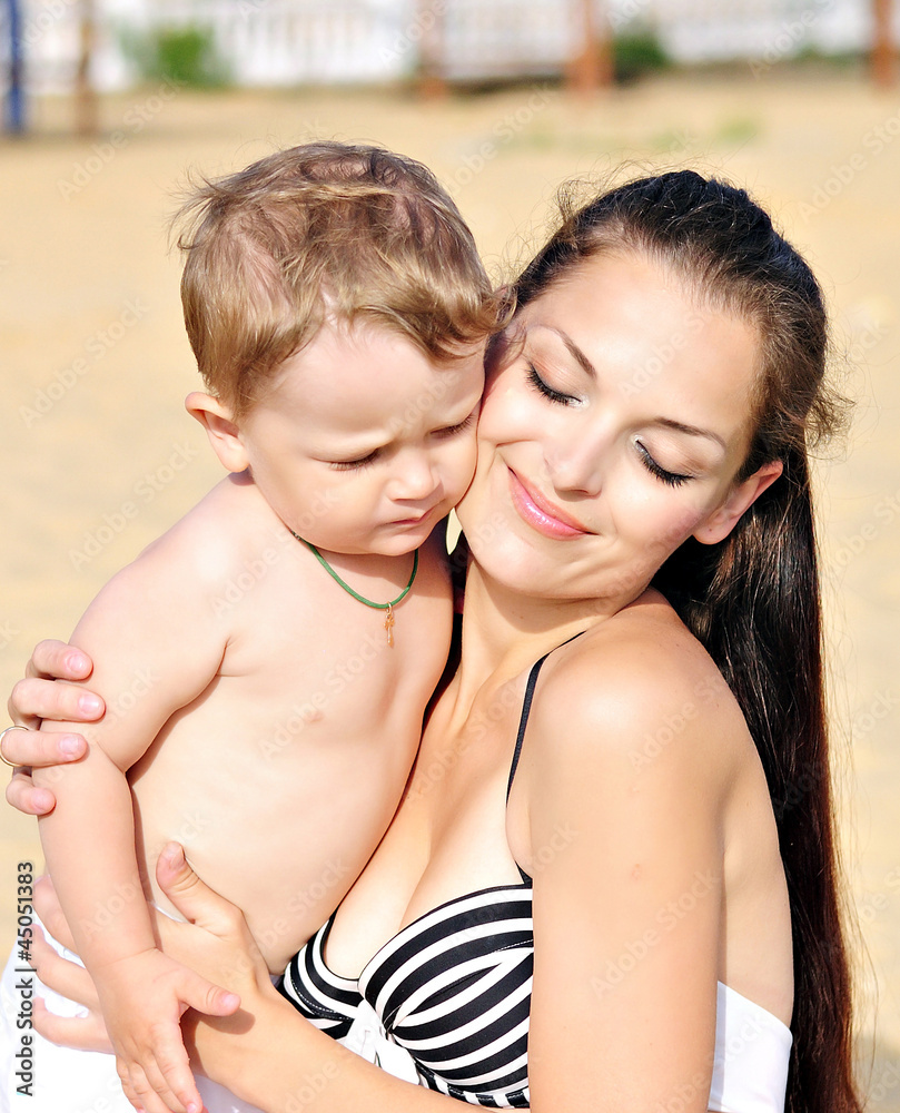 Mother with the child on sandy to seacoast Mother with the child on sandy to seacoast
