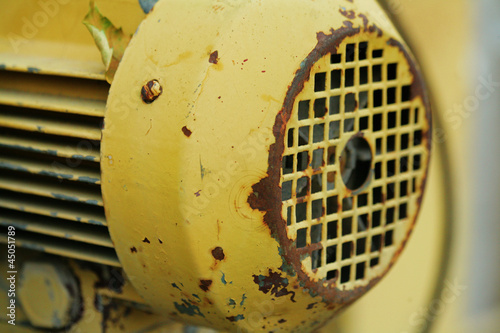 Old yellow motor with a rust