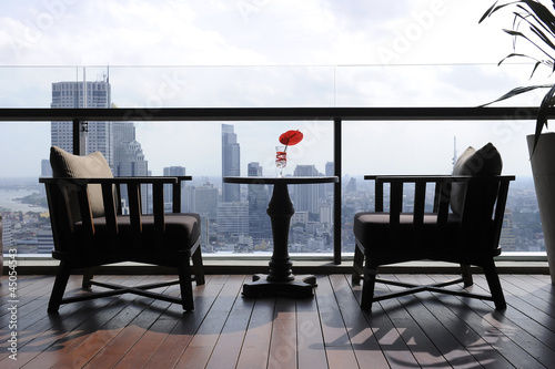 two chair at terrace restaurant with city view background