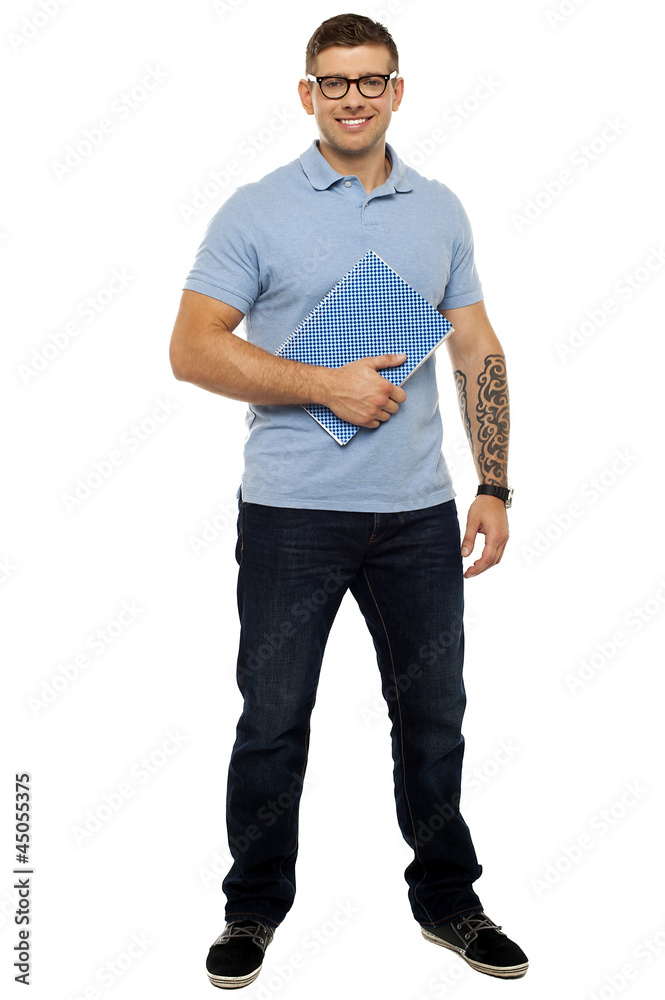 Fototapeta premium Casual young guy holding notebook