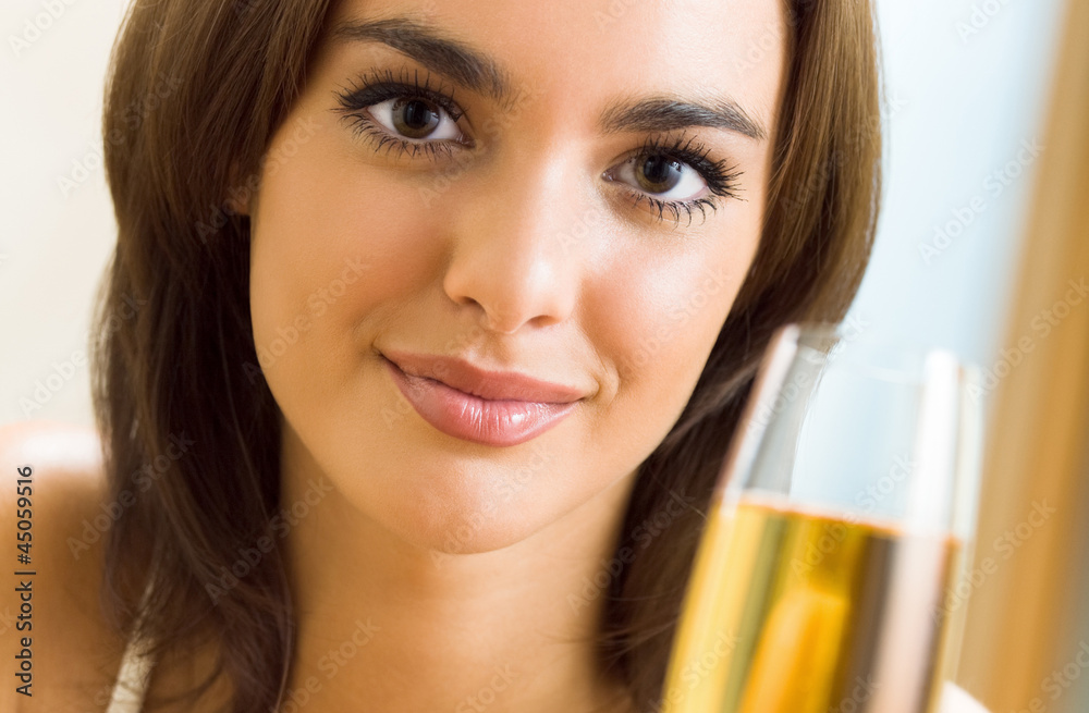 Woman with glass of champagne, at home Woman with glass of champagne, at home