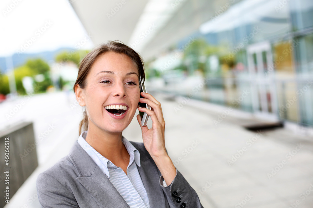 Cheerful businesswoman smiling on the phone Cheerful businesswoman smiling on the phone
