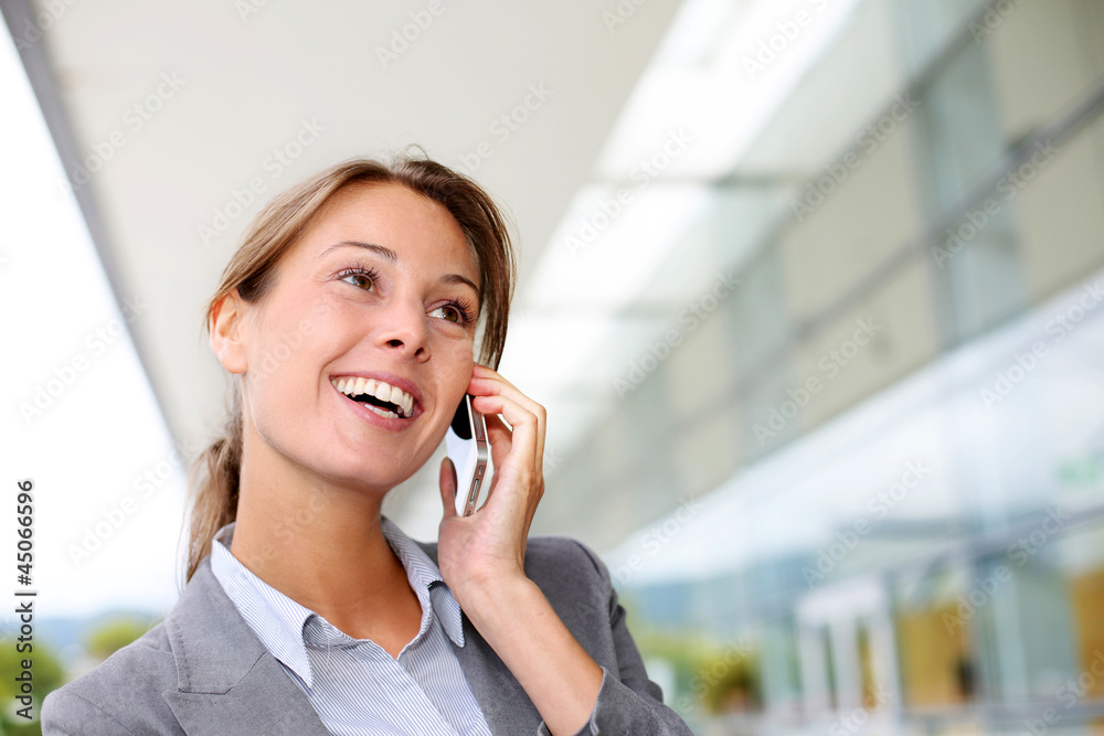 Smiling businesswoman talking on mobile phone Smiling businesswoman talking on mobile phone