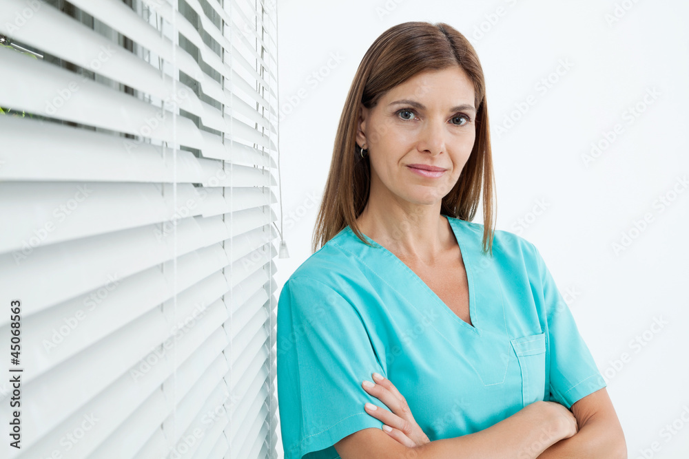 Confident Female Dentist In Clinic